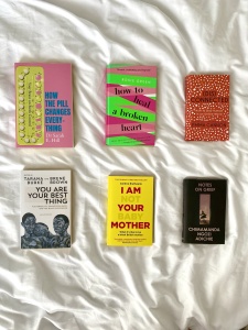Six books laid out, covers up, on a white bed sheet. The titles, are the same as those in the article. 